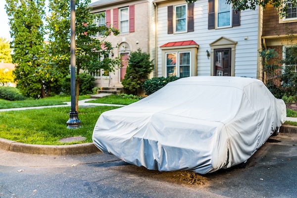 car covered in front of house