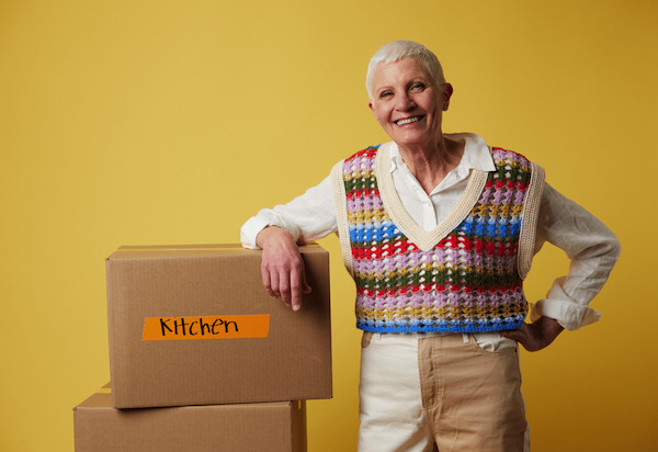 Woman with stack of storage boxes