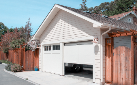 house with one garage door open and one closed